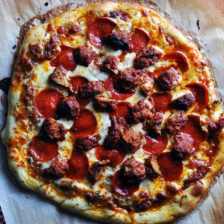 Homemade pizza with meatballs and pepperoni.