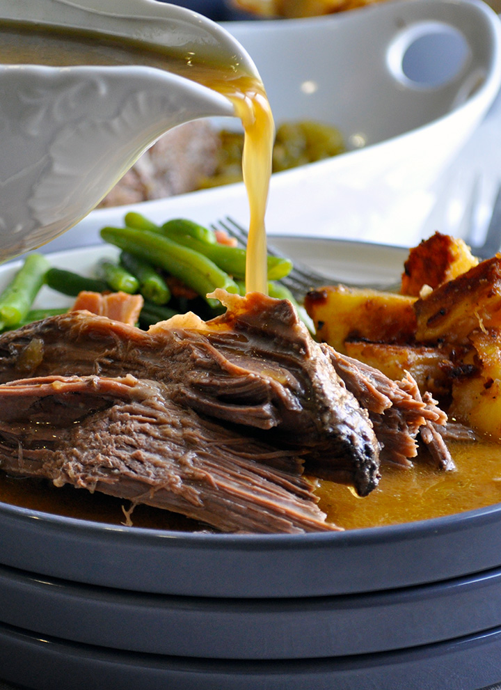 Pouring gravy on slow Cooker Beef Pot roast