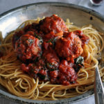 Spaghetti and homemade meatballs in marinara sauce.