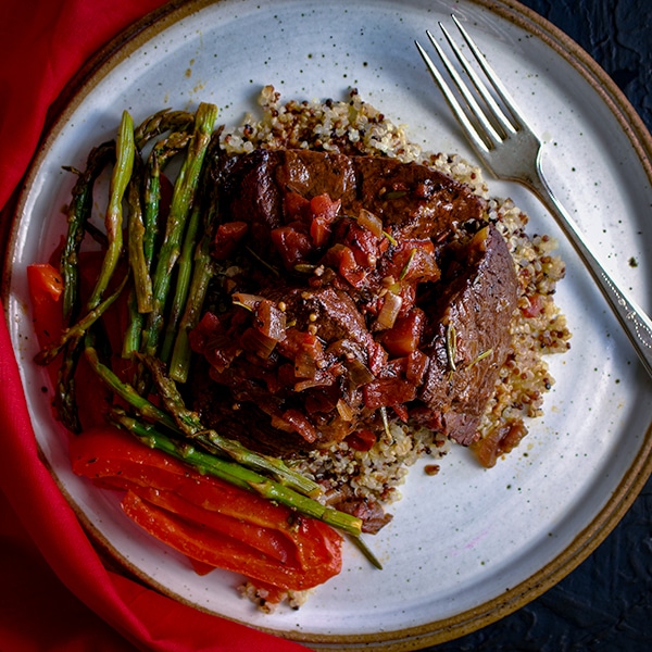 Rosemary Braised Steak Tips with Quinoa and sautéed asparagus and red bell peppers.