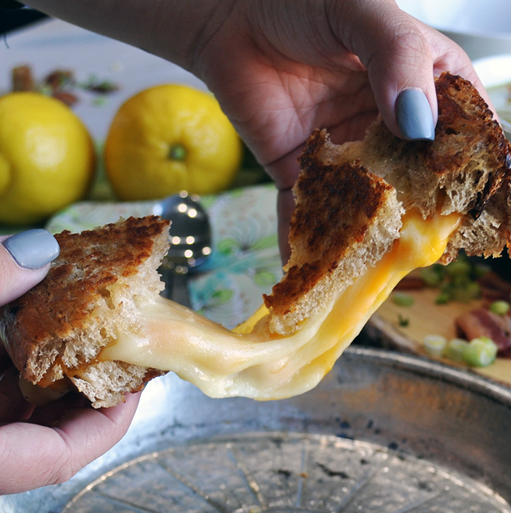 Pulling apart a grilled cheese sandwich.