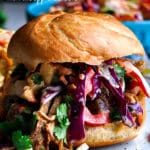 A pulled pork sandwich with pineapple coleslaw.
