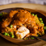 A bowl of Homemade Indian Butter Chicken with Indian Rice.