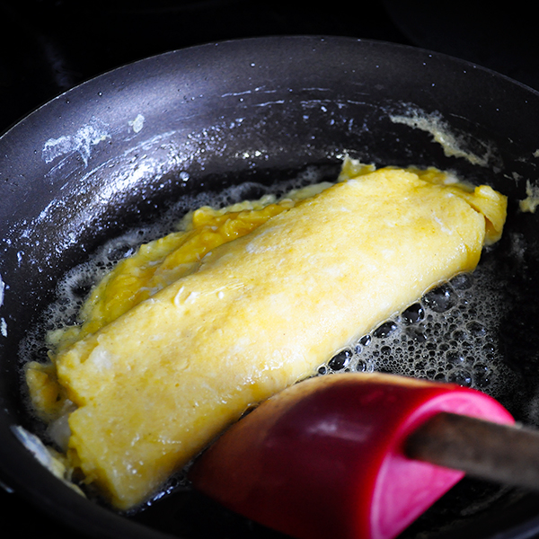Turning a French Omelette in the pan.
