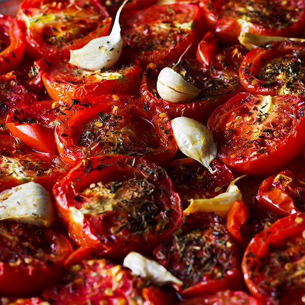 A tray of roasted tomatoes and garlic for Roasted Tomato Sauce with Garlic and Herbs.