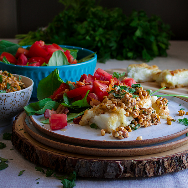 Skillet cooked cod fillets with creamy corn relish and tomato salad.