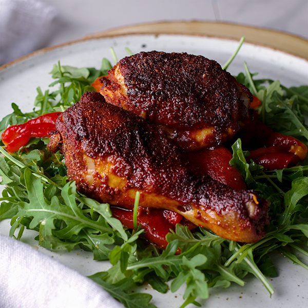 Paprika Chicken with Marinated Peppers on arugula salad.