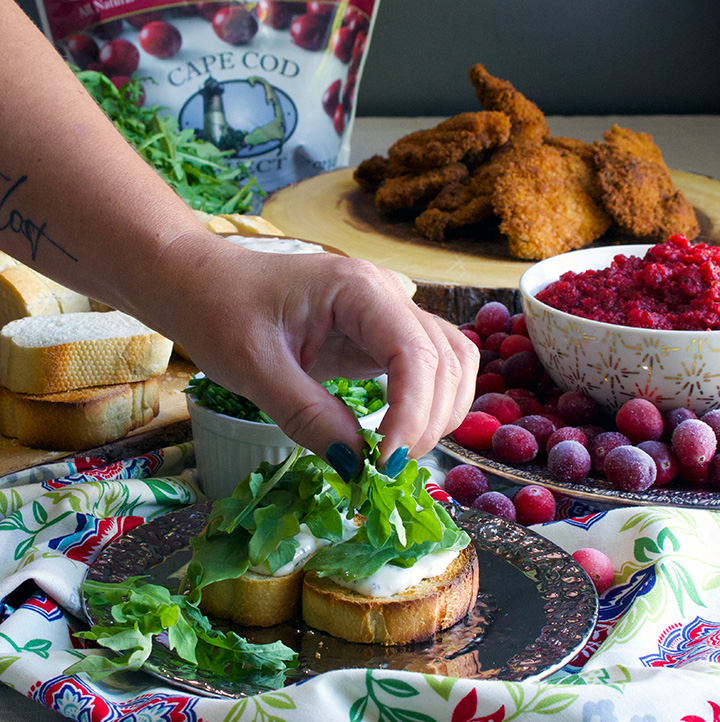 Putting arugula on Fried chicken sandwiches with savory mayonnaise, arugula, and spicy cranberry relish.