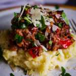 A plate of Tuscan Braised Beef over Garlic Mascarpone Mashed Potatoes.