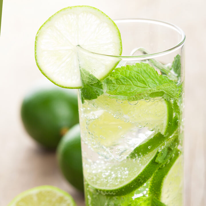 A cuban mojito with lime slices and mint.
