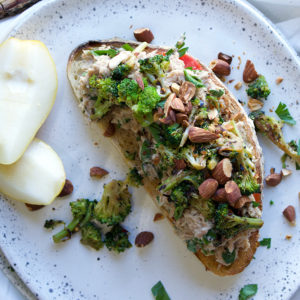 Open face Italian Tuna Sandwich with sautéed broccoli, tomatoes, and roasted almonds