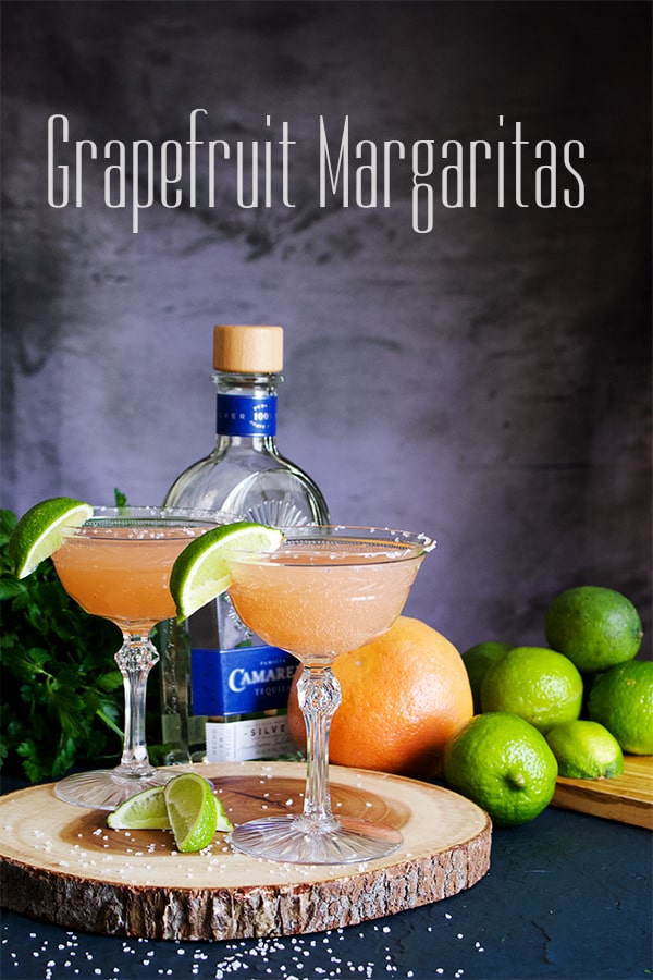 A wood tray with two glasses of Grapefruit Margaritas.