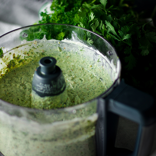 Creamy avocado and herb sauce in the food processor.
