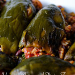 A pan of stuffed poblano peppers in a white baking dish.