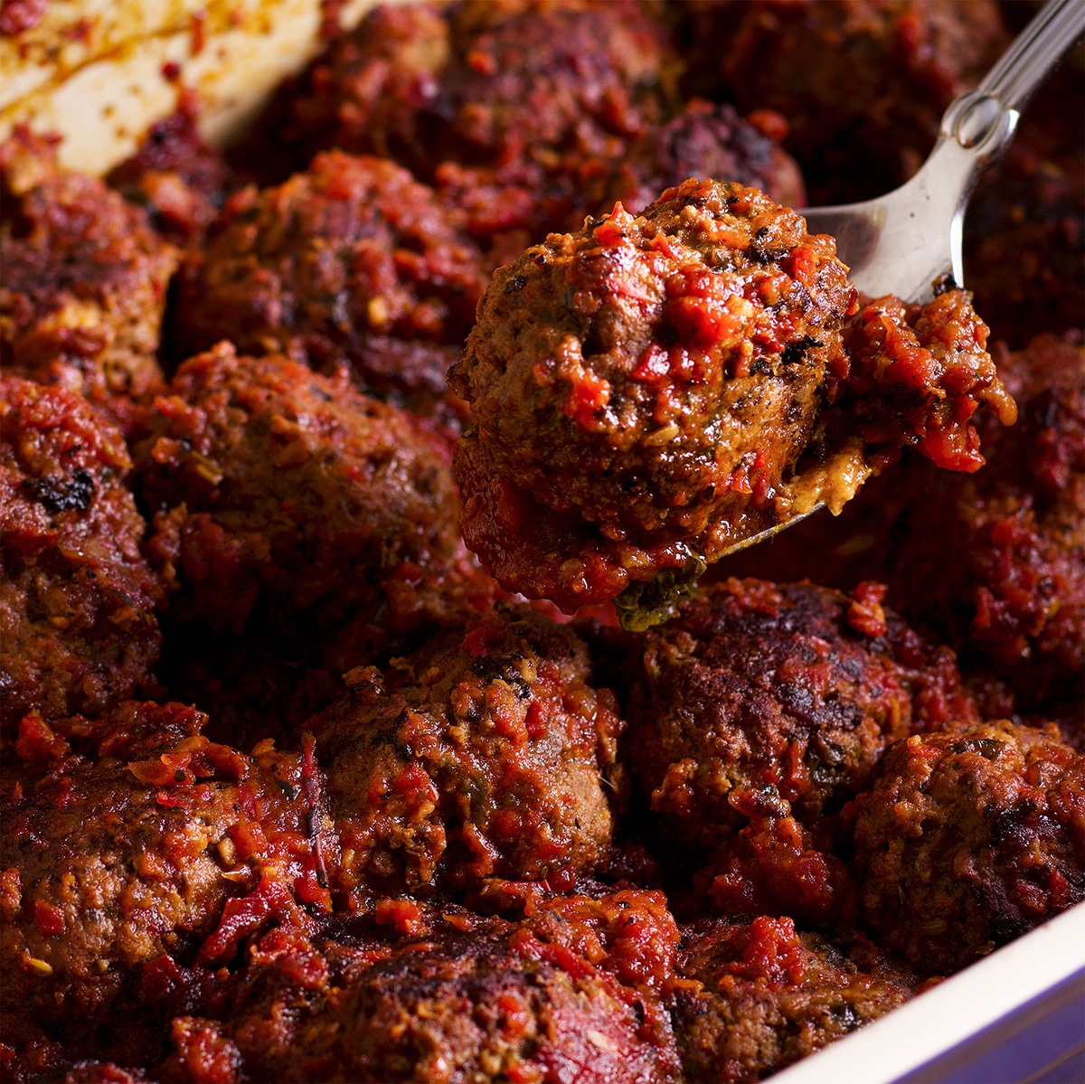 A baking dish filled with meatballs in marinara, freshly baked and ready to serve.