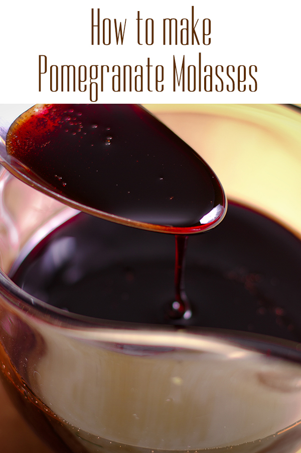 Spooning out a tablespoon of homemade pomegranate molasses.