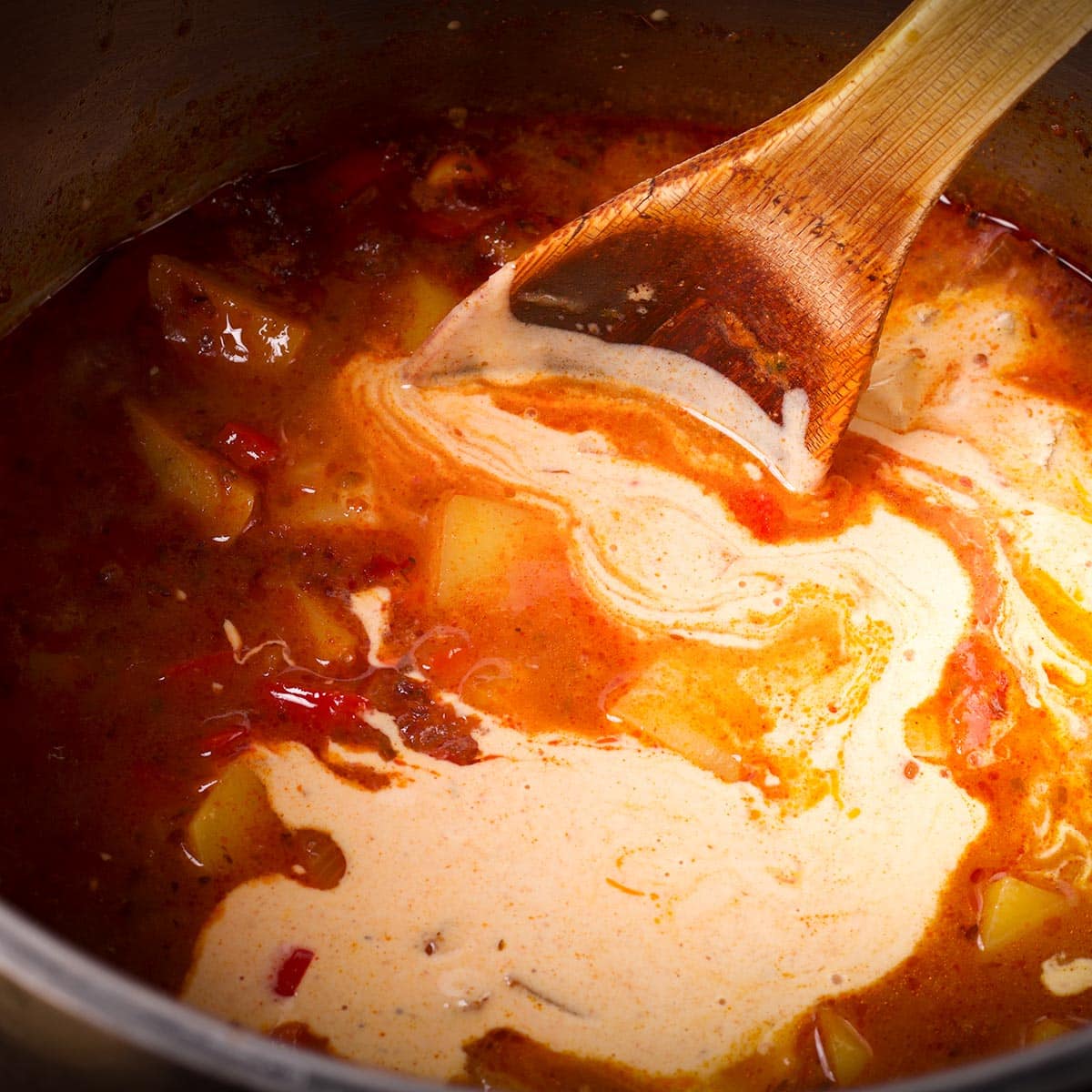 Pour the sour cream and broth mixture back into the soup pot and stir to mix everything together.