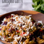 A bowl of vegetarian cauliflower chickpea curry with coconut.