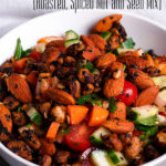 Yemenite Ja'ala, a roasted, spiced nut and seed mix, sprinkled over a bowl of salad.