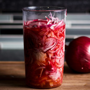 A jar of pickled red onions.
