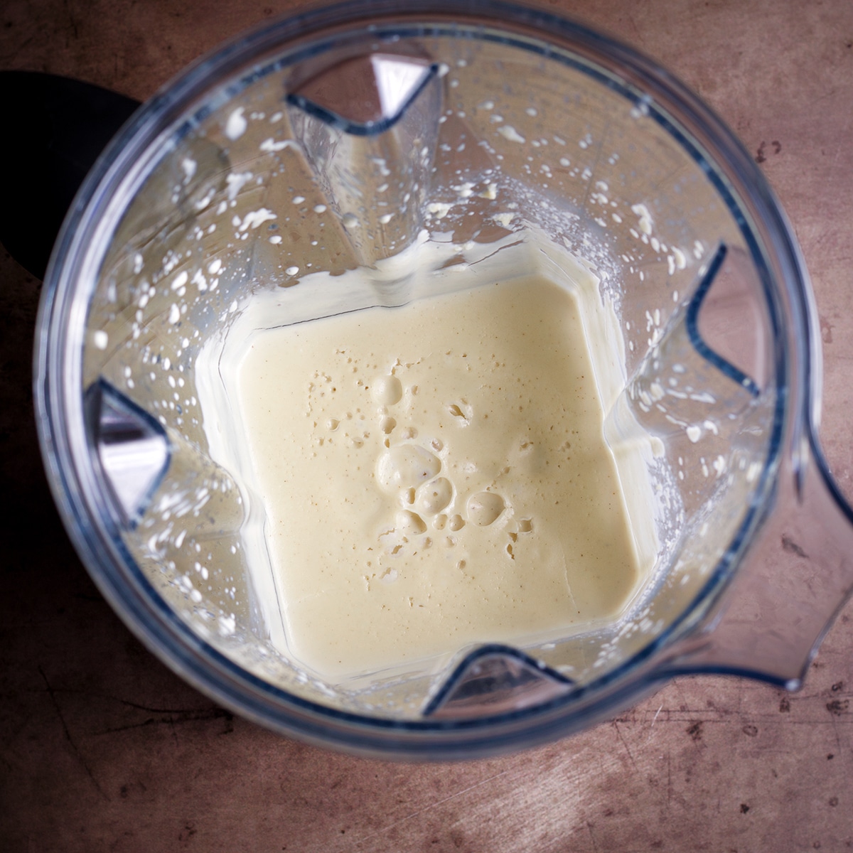 Using a high-powered blender to make vegan sour cream.