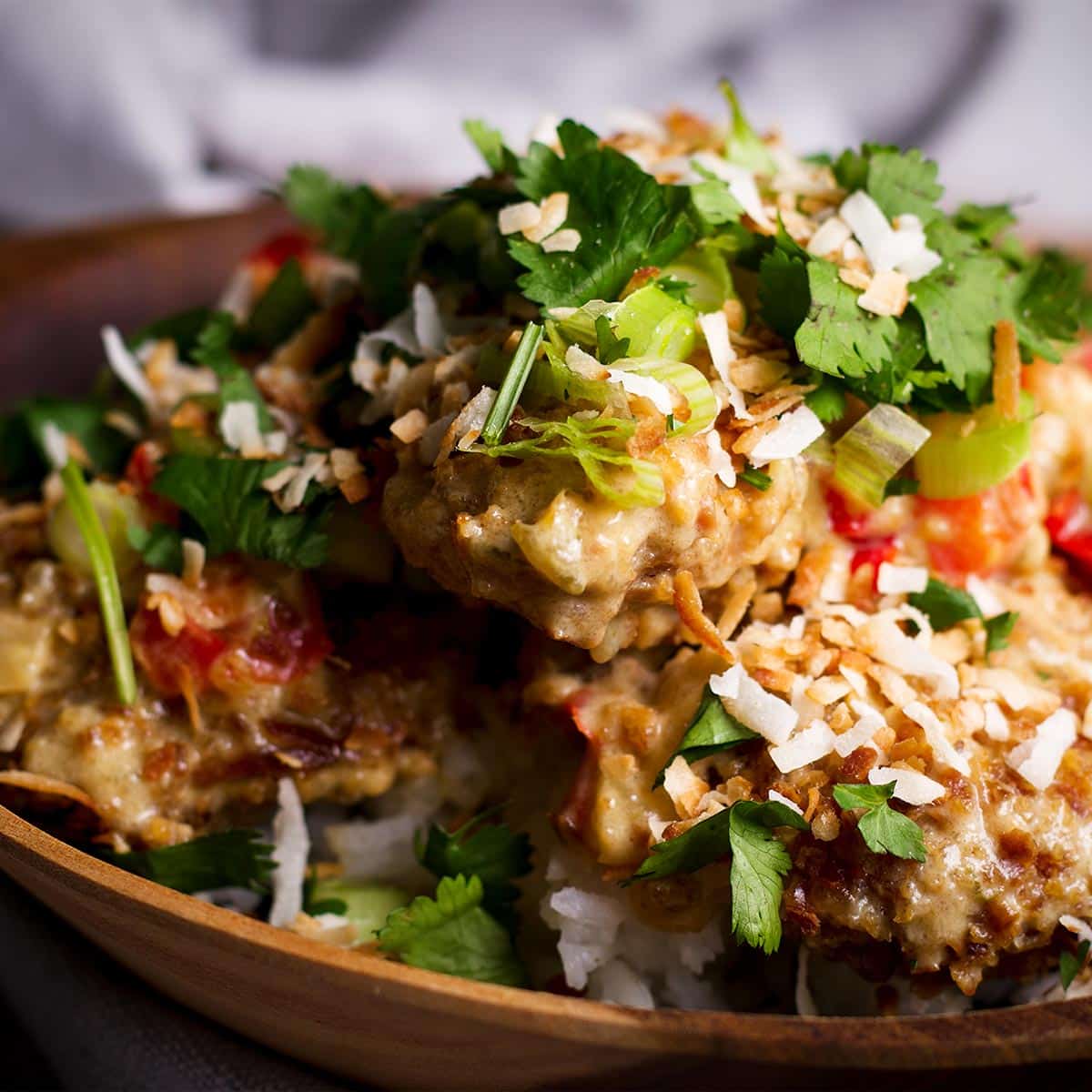 A bowl filled with rice and coconut lime chicken.