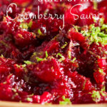 A bowl of chili cranberry sauce with lime zest sprinkled over the top.