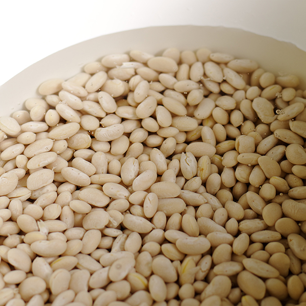Soaking white beans before cooking them.