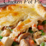 A piece of classic double crust chicken pot pie on a plate.