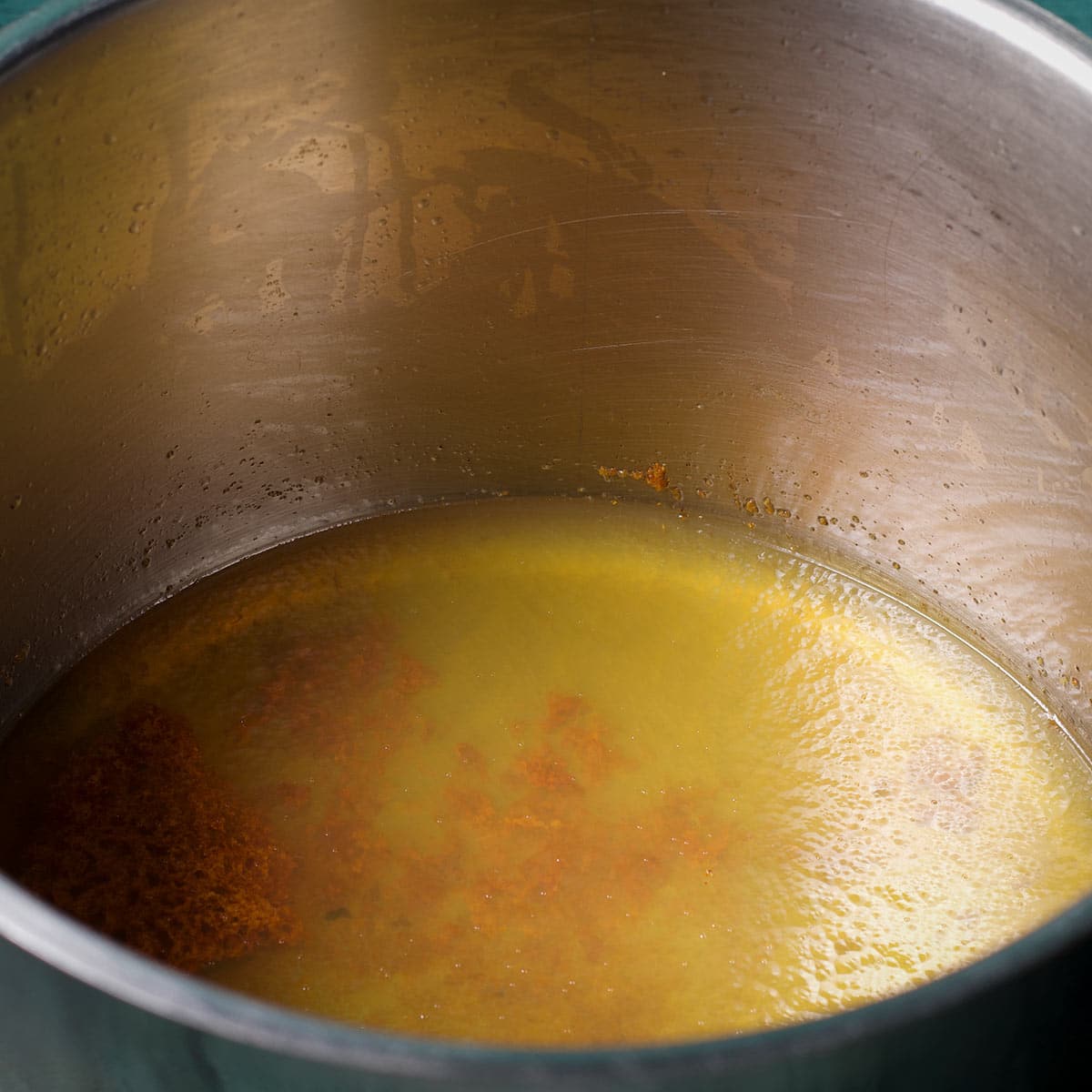 A stockpot filled with used frying oil that's been turned solid by adding Fry Away.