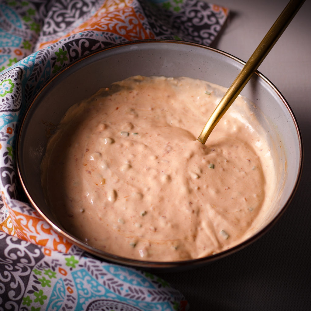A blue bowl filled with homemade Russian Dressing.