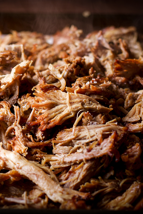 A platter filled with freshly cooked pork carnitas.