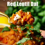 Taking a bite of red lentil dal.