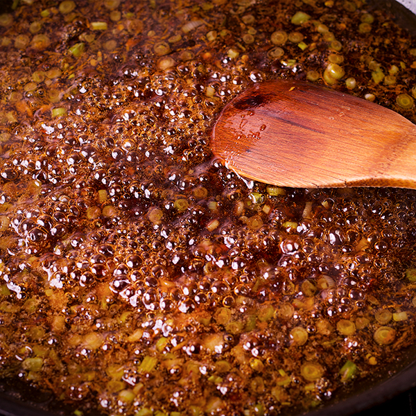 Stirring a pan of simmering General Tso's Sauce.
