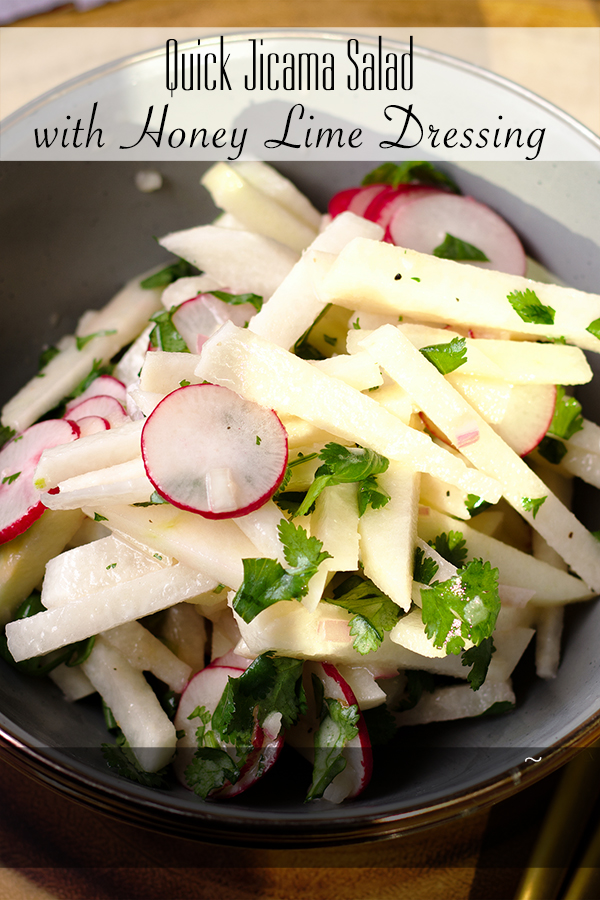 A bowl filled with jicama and apple salad with honey lime dressing.