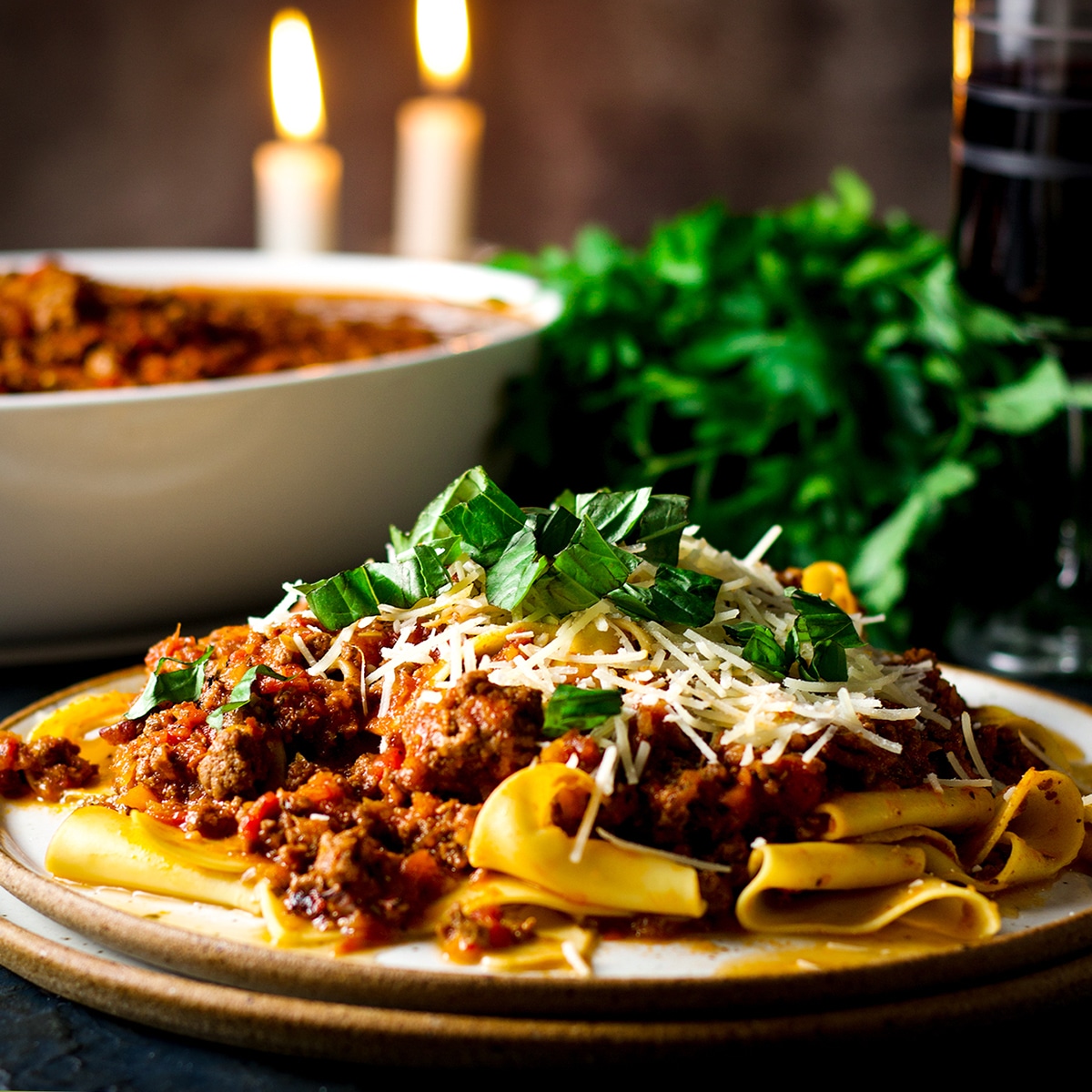 A plate of pasta smothered in homemade bolognese sauce.