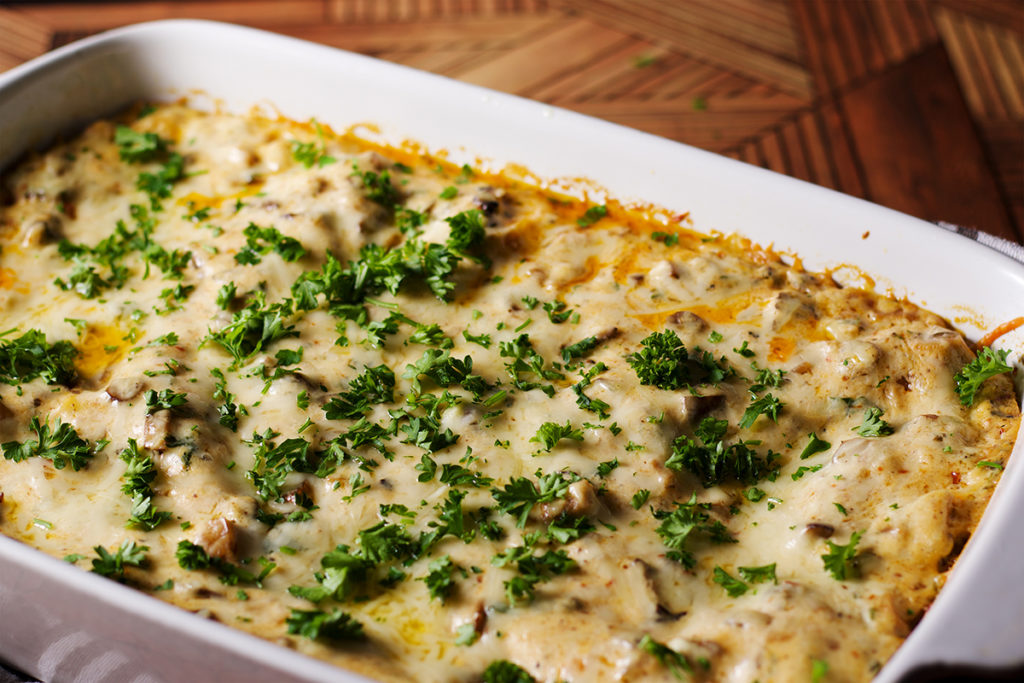 A freshly baked pan of white mushroom lasagna, ready to serve.