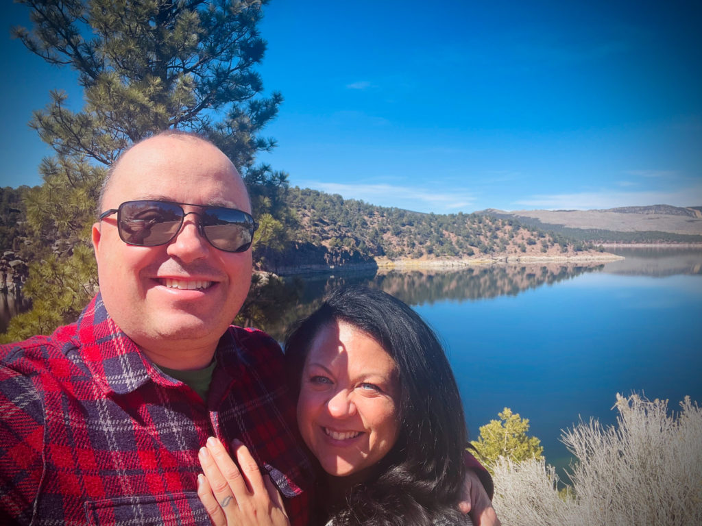 Steve and Rebecca Blackwell standing in front of the water at The Flaming Gorge in Utah.