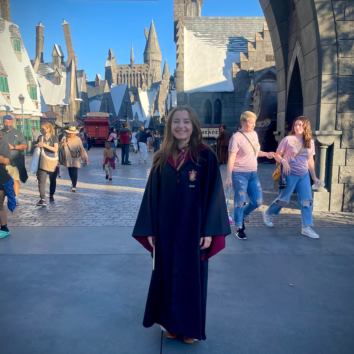 Annie standing in the middle of a street in the Hogwarts exhibit at Universal Studios, California.