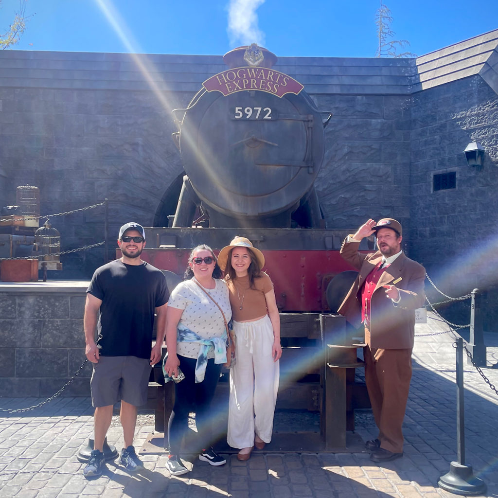 Scott, Kate, and Anne standing in front of the Hogwarts Express at Universal Studios Hollywood.