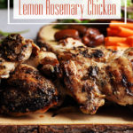 A wood serving platter piled high with grilled lemon rosemary chicken.