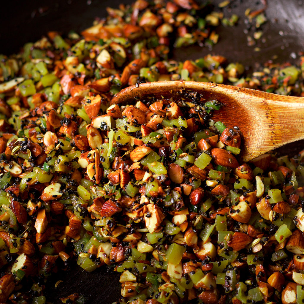 A photo showing all the ingredients for almond salsa in a skillet.