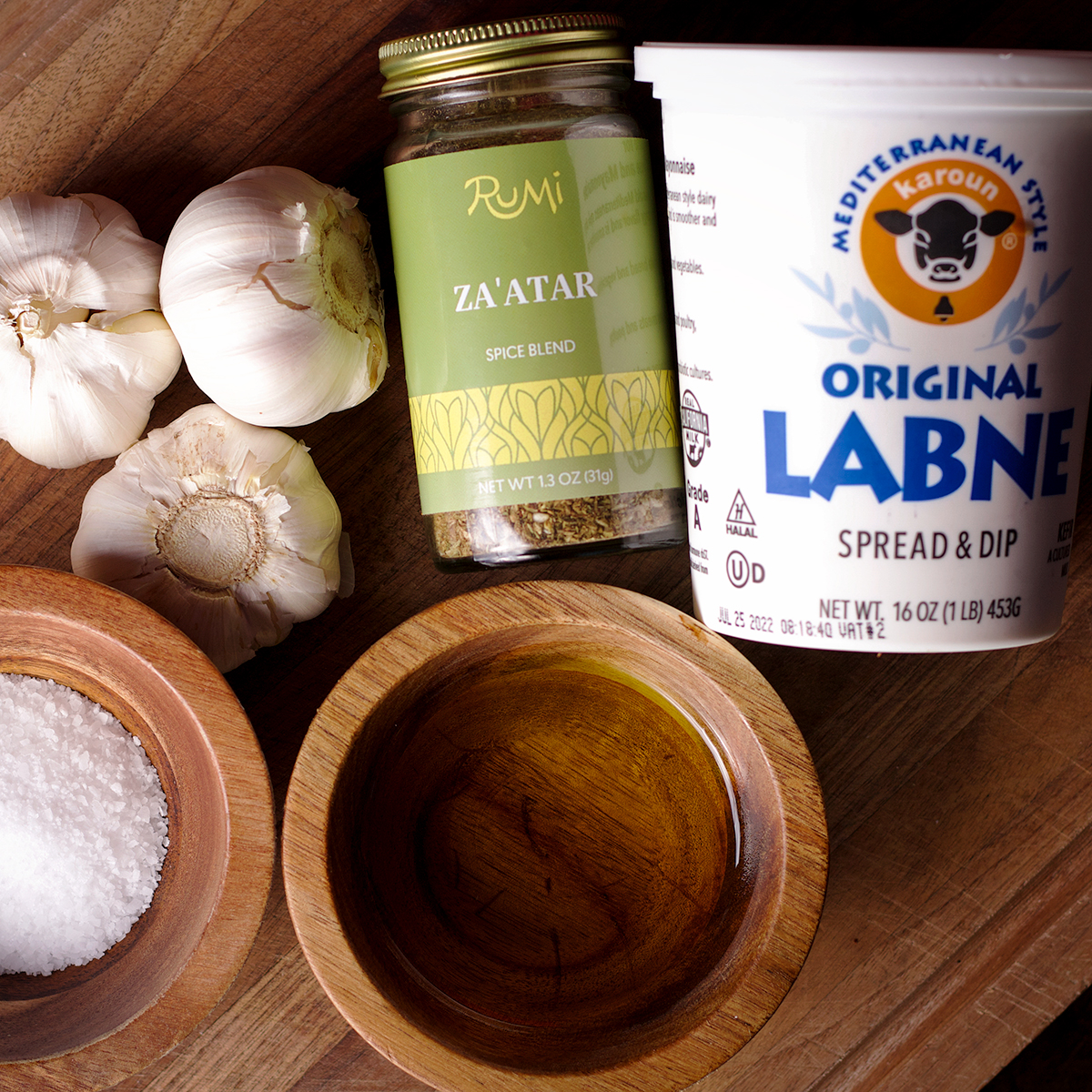 A wood tray holding all the ingredients to make za'atar labneh.