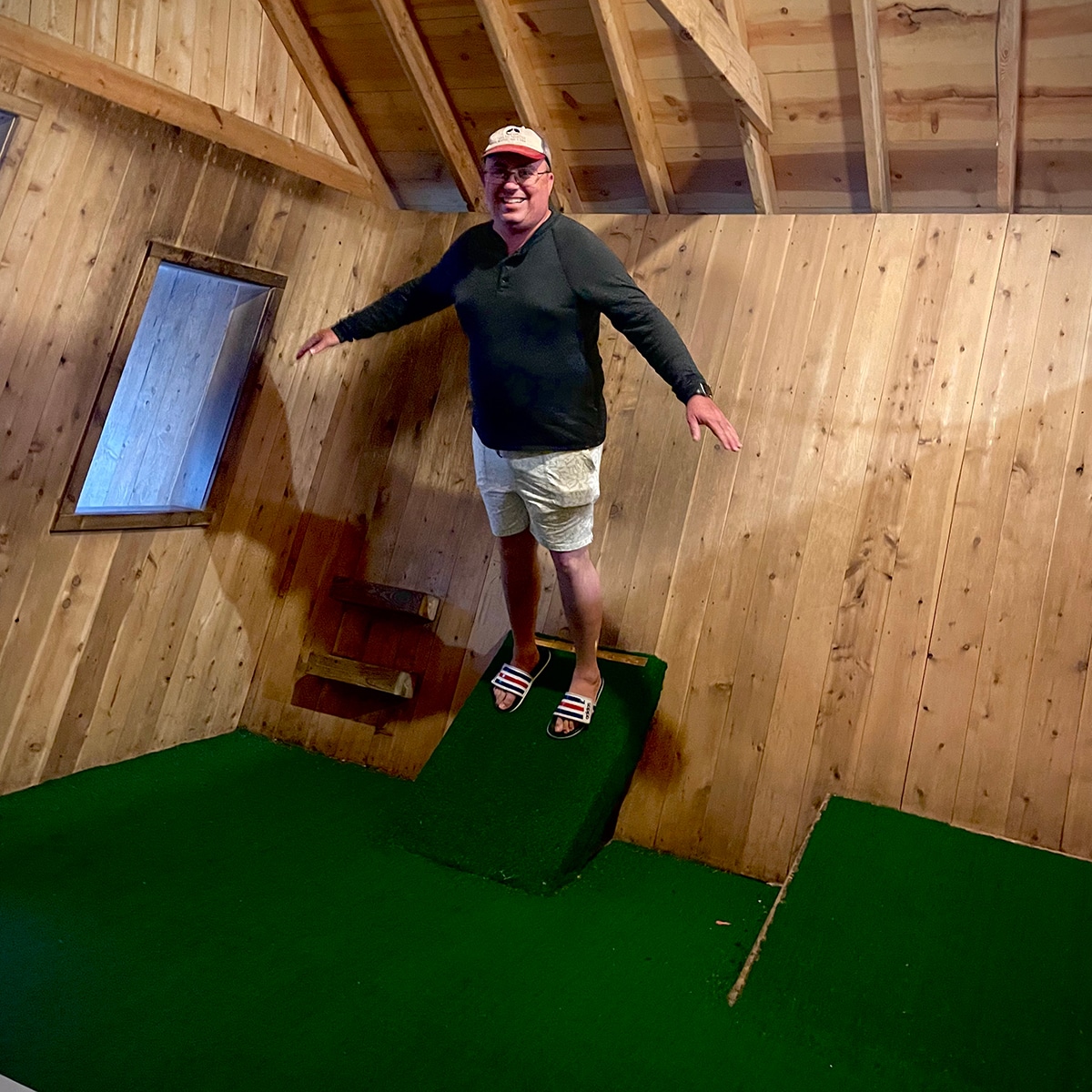 Steve balancing in a room that presents an optical illusion of being crooked at The Mystery Spot in Michigan's UP.