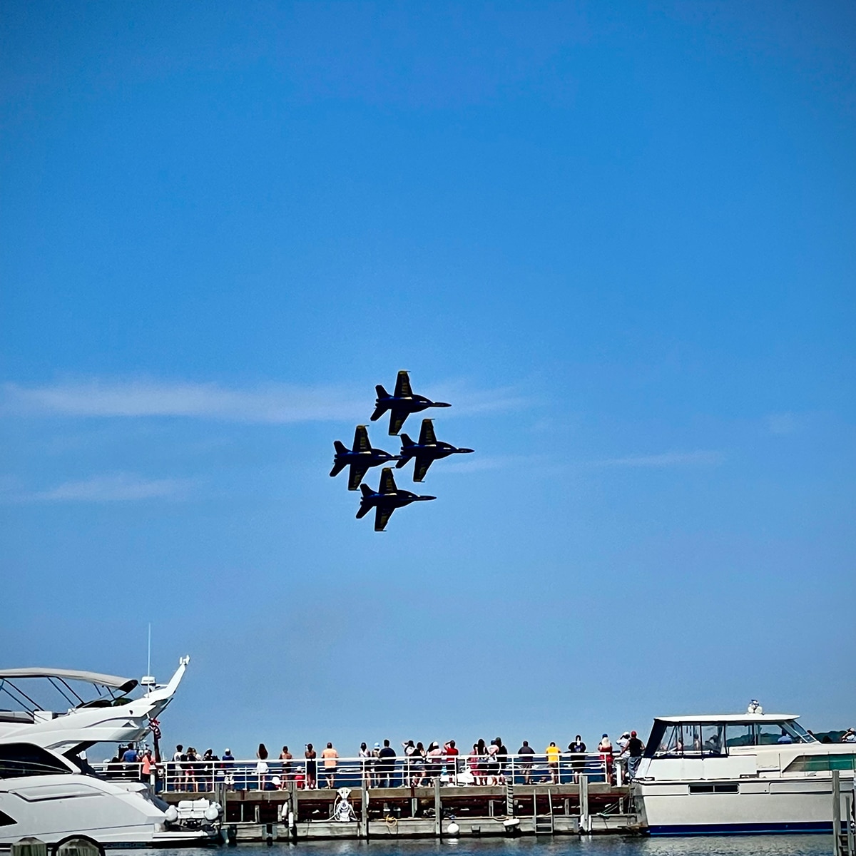 Four Blue Angel airplanes in the air during an air show at the 2022 Traverse City Cherry Festival.