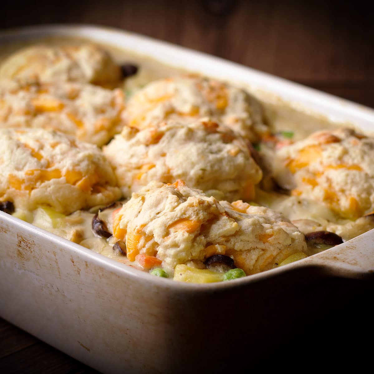 A biscuit topped turkey pot pie that's been baked in a rectangle casserole dish.