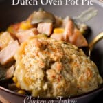 A blue bowl filled with biscuit topped turkey pot pie that was cooked in a dutch oven.