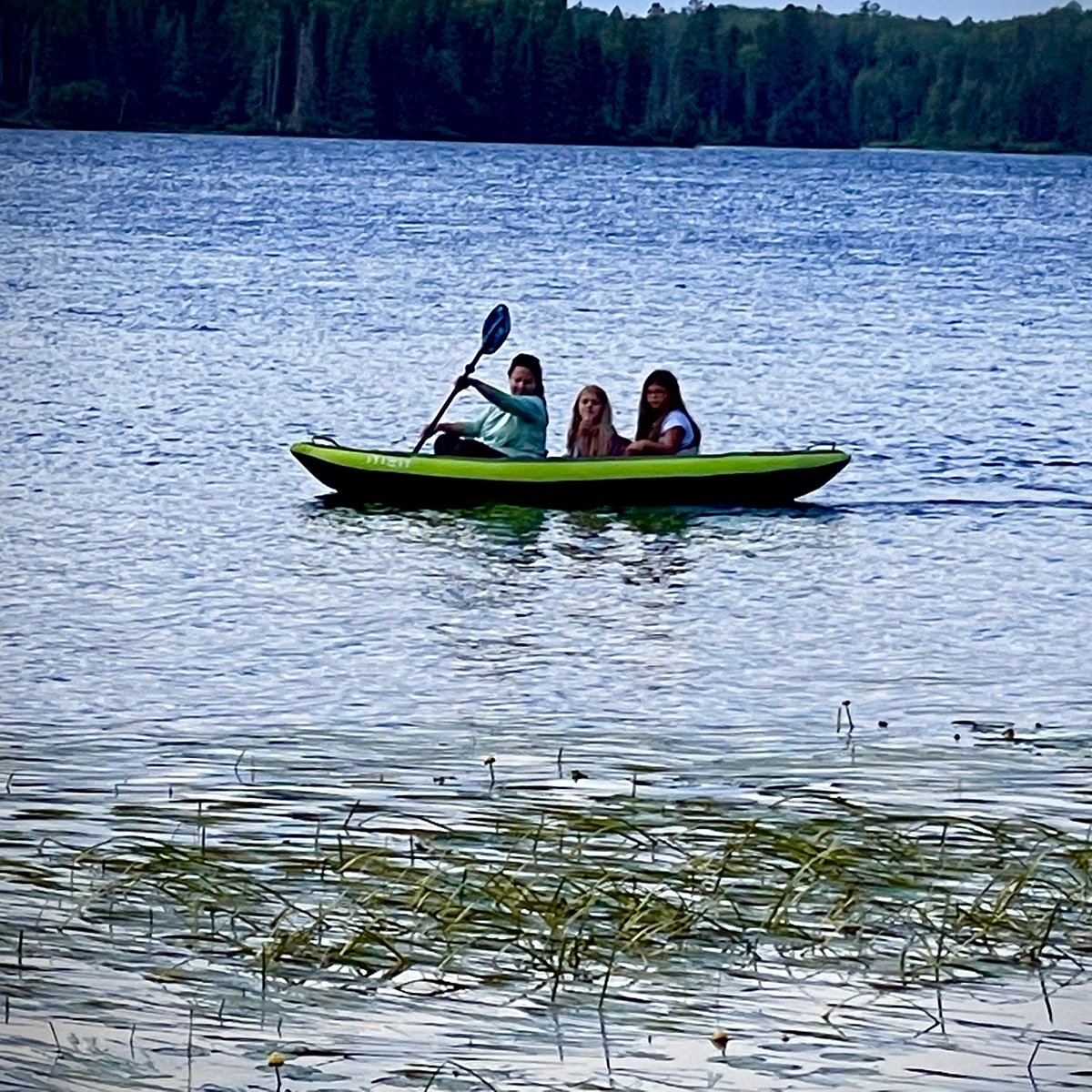 Rebecca in a kayak on Day Lake, taking two little girls for a ride.