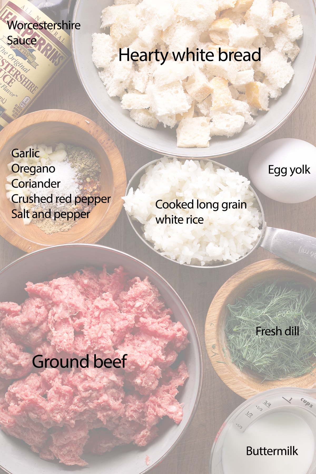 All of the ingredients needed to make Greek meatballs on a wood cutting board.