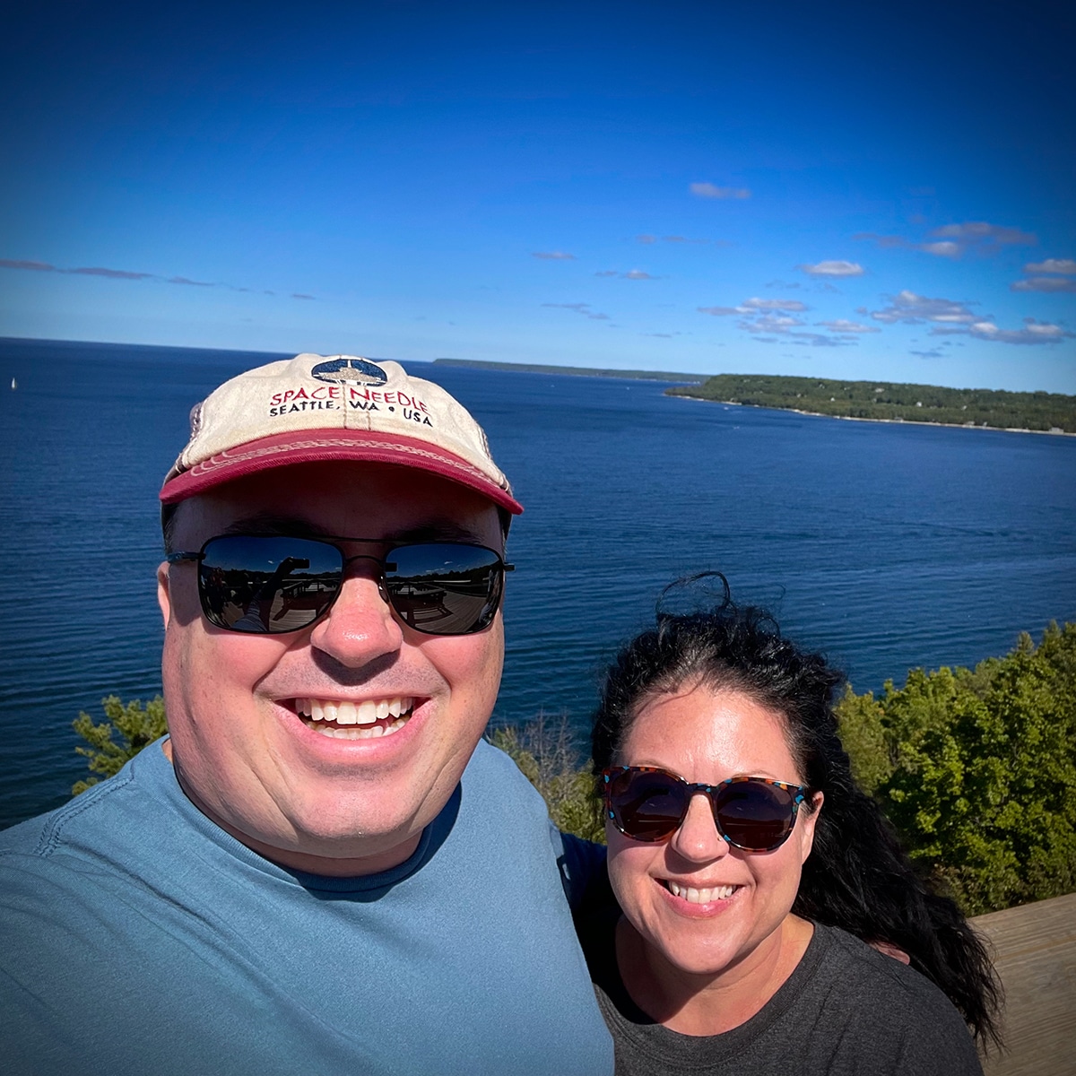Steve and Rebecca Blackwell standing on the coast of Door County with Lake Michigan behind them.